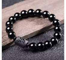 Бусина Дзі Фенікс у браслеті з чорного обсидіана підсилює енергетику людини, удачу та здоров'я активує